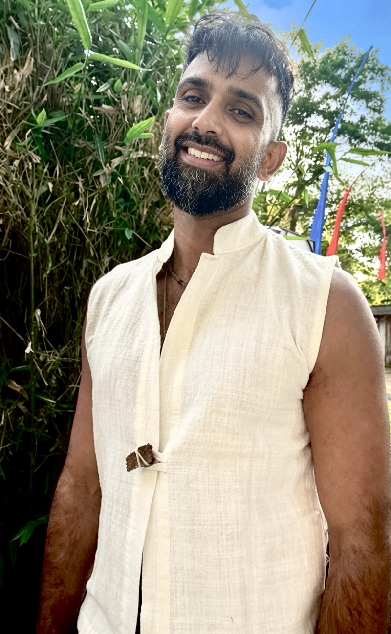 Dr. Manish smiling in a SOICHU ivory vest at Naya Veda Vastu, Ubud
